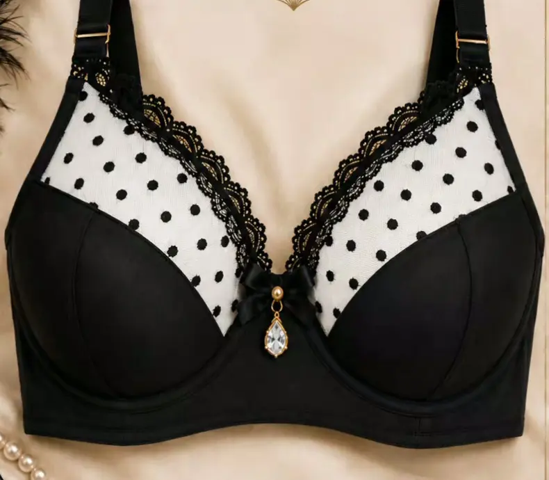 Black polka dot bra with lace trim and a pearl drop
